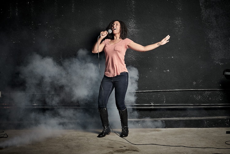 Student performing onstage in School of Rock's Adult Performance Music Program